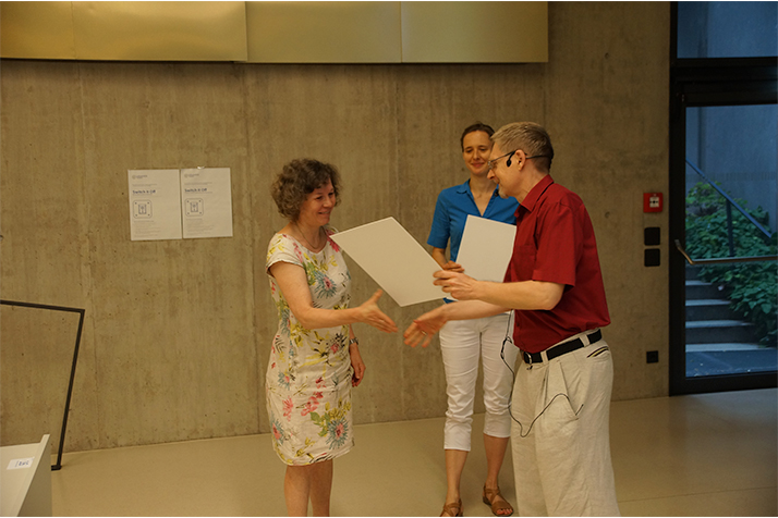 Dekan Gansterer überreicht Dr. Katerina Schindlerova eine Urkunde. Im Hintergrund steht Ass.-Prof. Kathrin Hanauer.